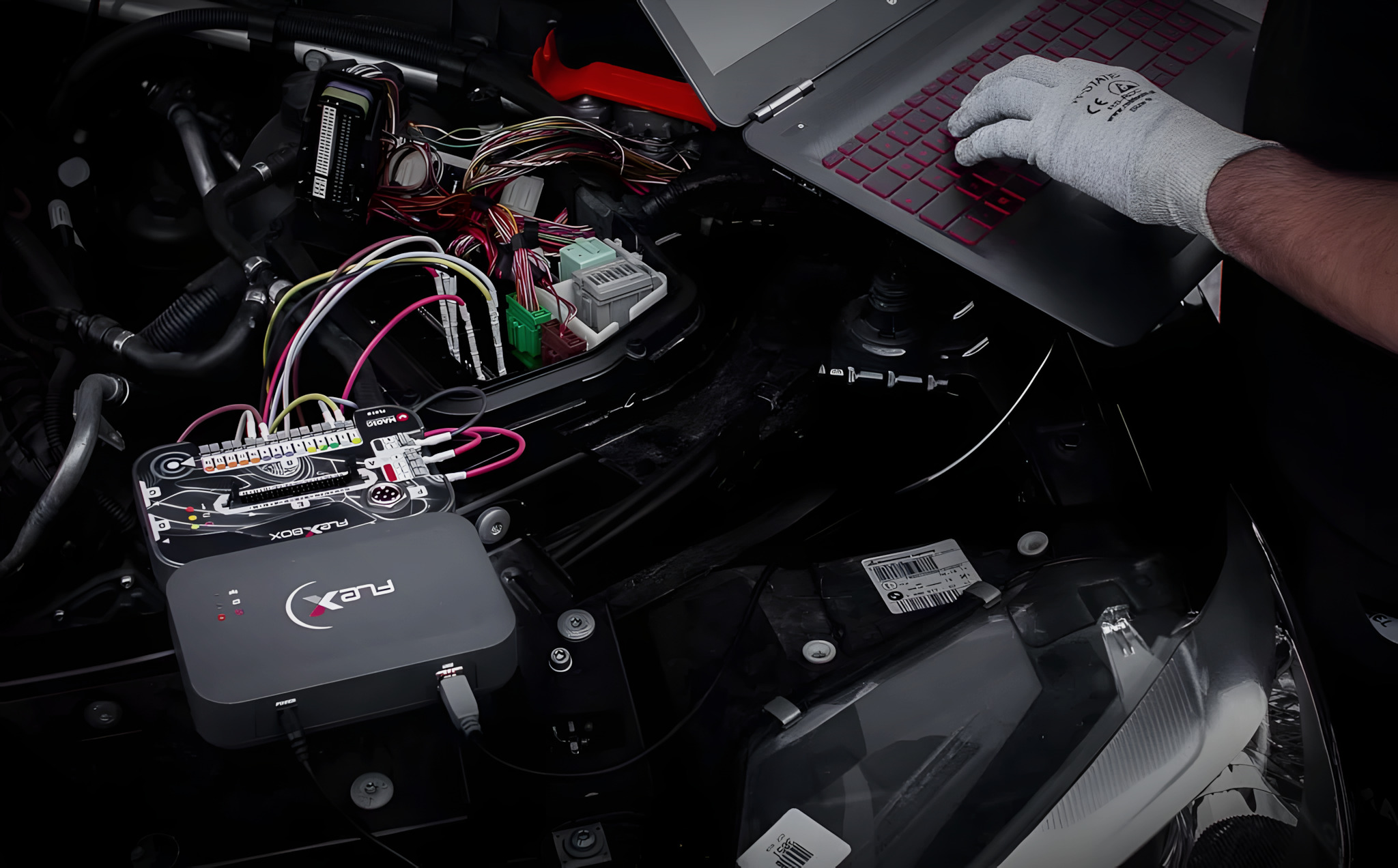 Professional ECU tuning equipment connected to a vehicle engine